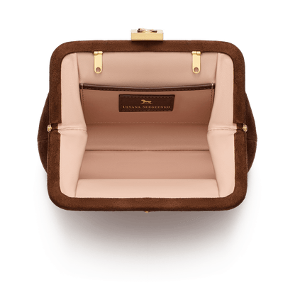 Suede bag with signature clasp and removable strap
