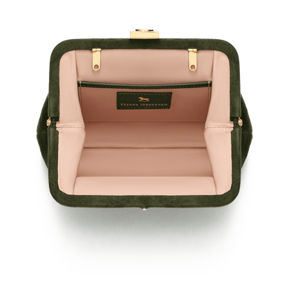 Suede bag with signature clasp and removable strap