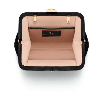 Suede bag with signature clasp and removable strap